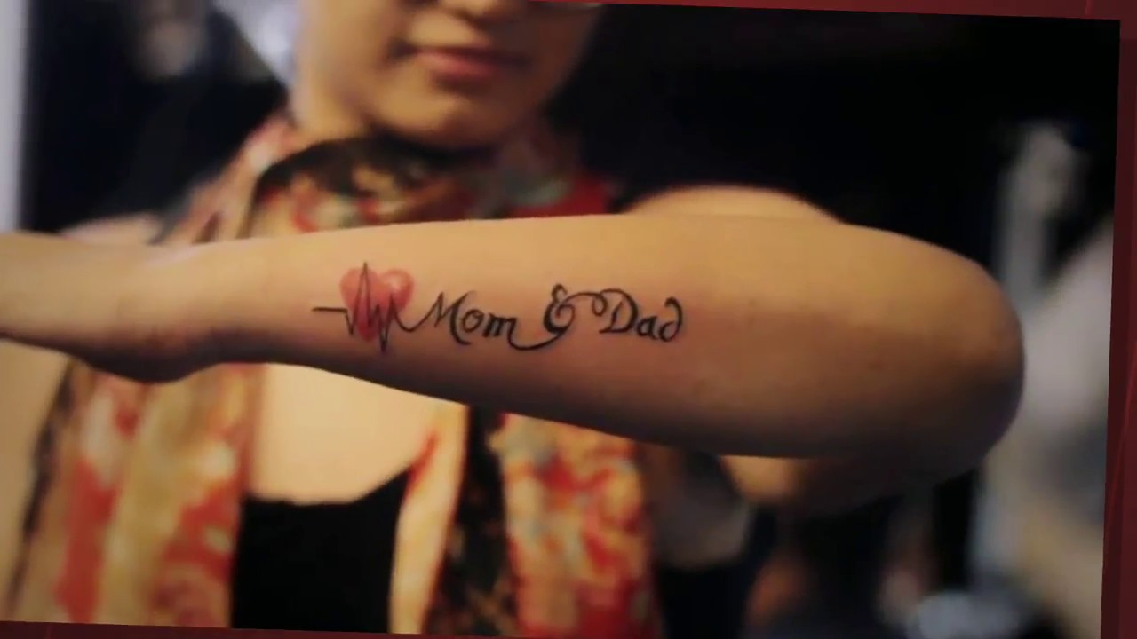 Dad and Mum tattoo on Andreas wrists