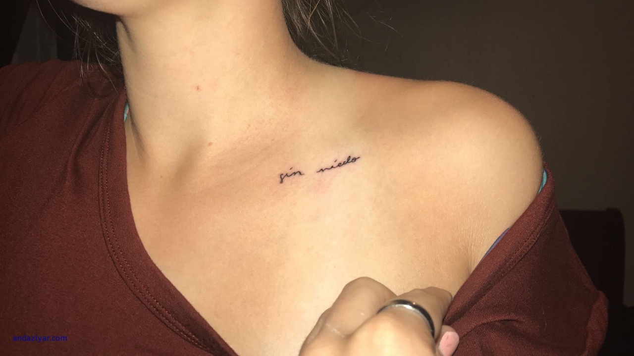 Tiny little heart tattoed on the shoulder minimalistic