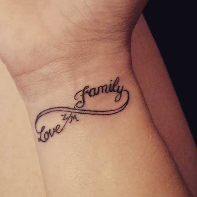 Forearm tattoo saying Sisters love forever
